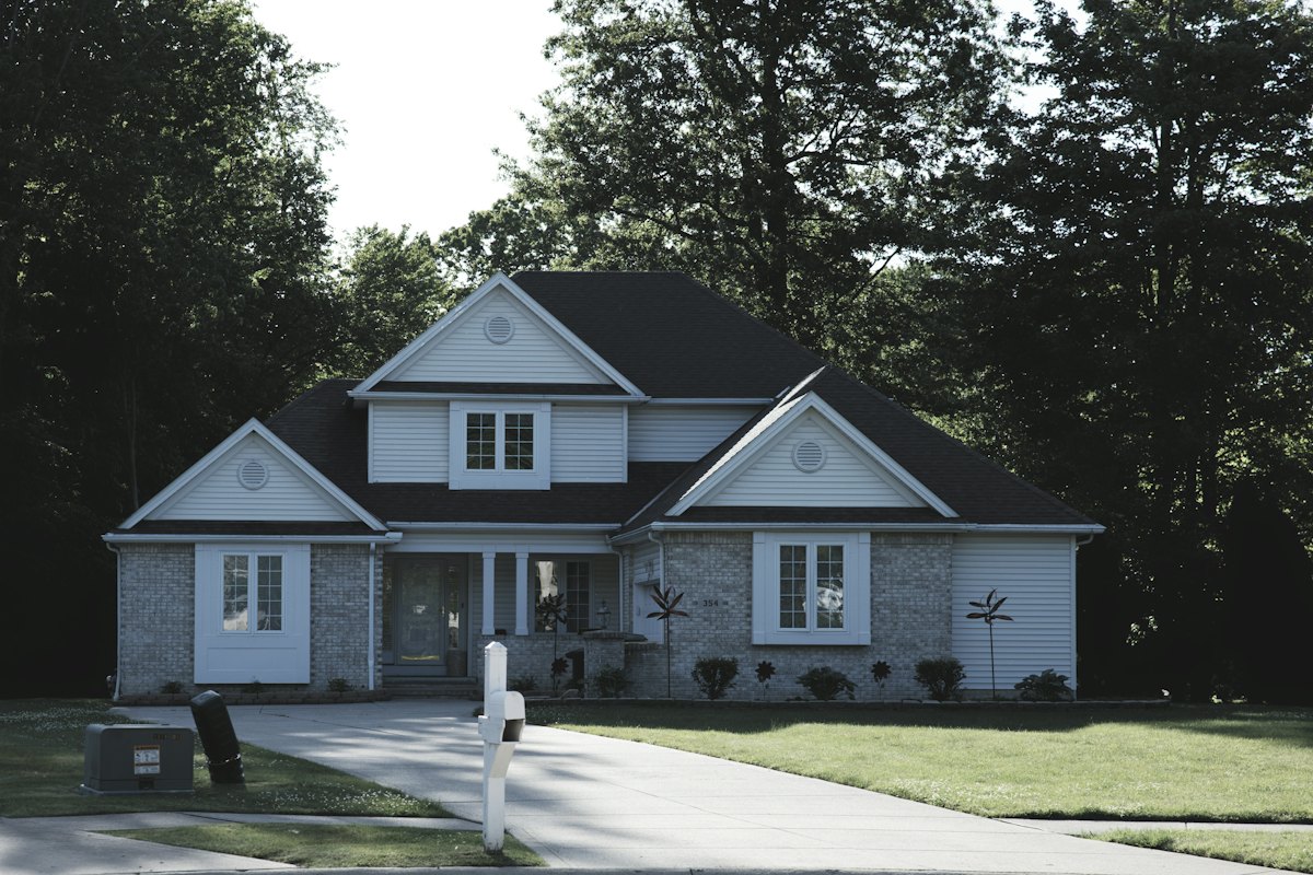 Two-story suburban family home on a tree-lined street