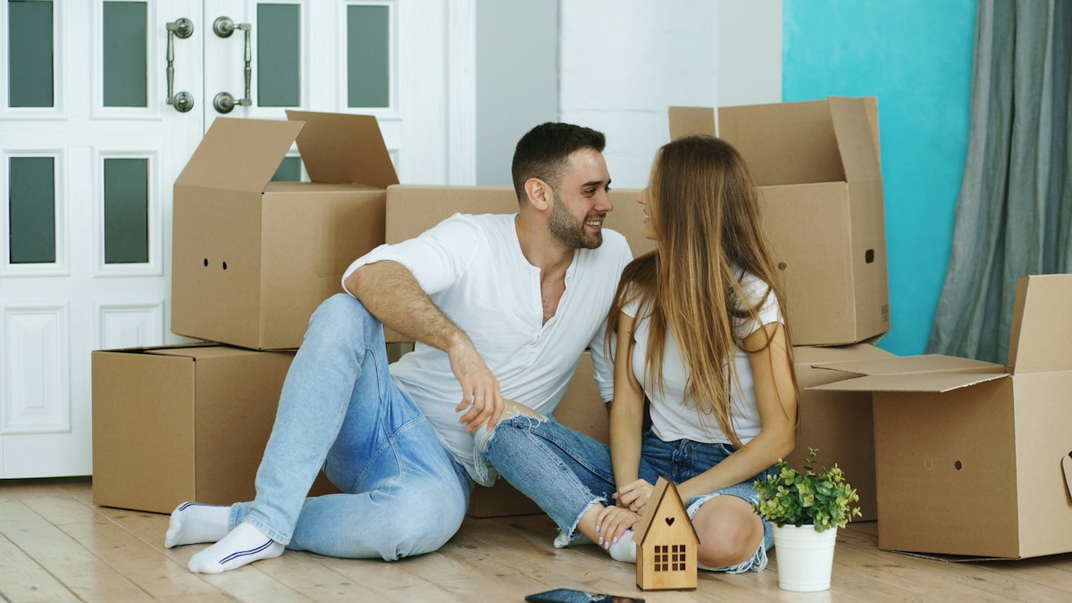 Couple unpacking boxes in their new home